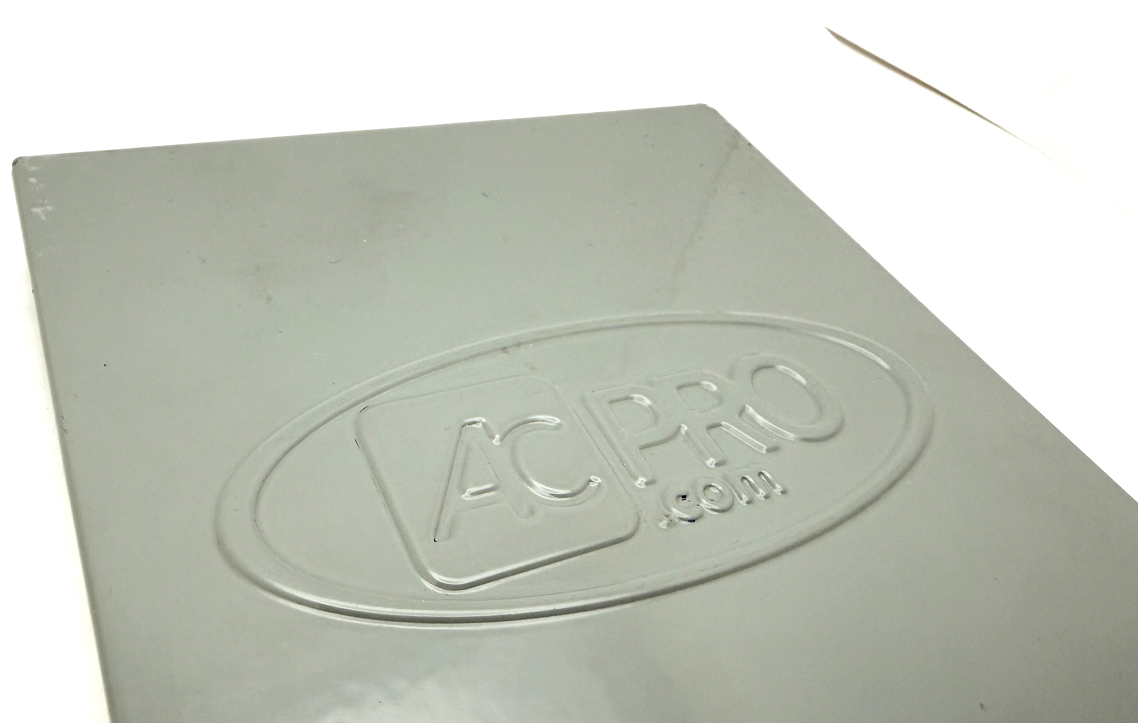 Full view of custom embossed AC PRO logo on painted gray panel