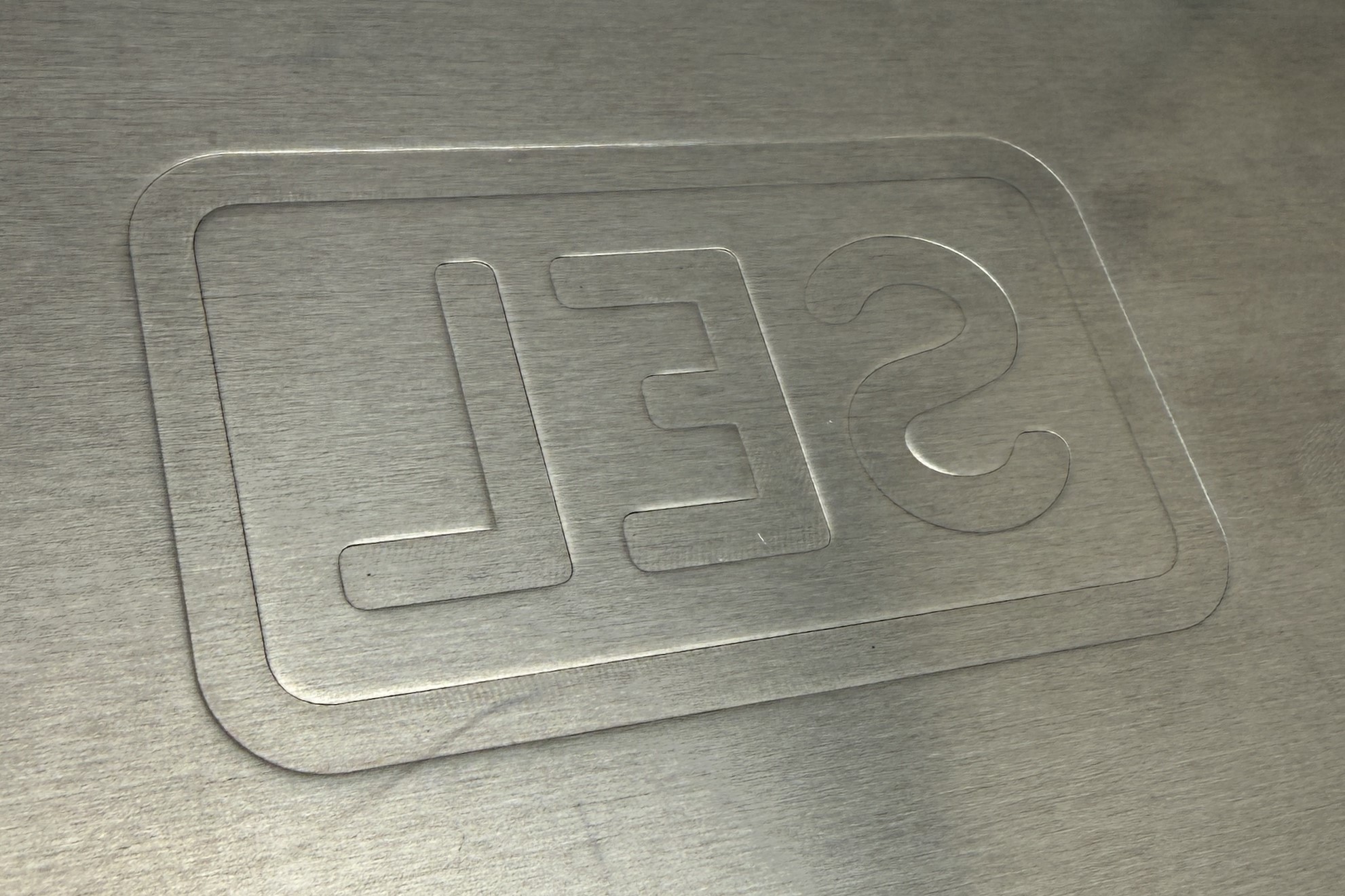 Full view of custom embossed AC PRO logo on painted gray panel